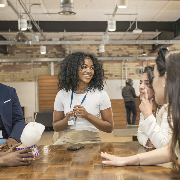 students around a table in London campus