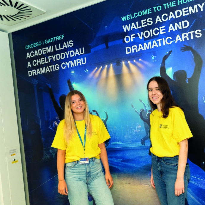 Student Ambassadors standing in front of WAVDA banner