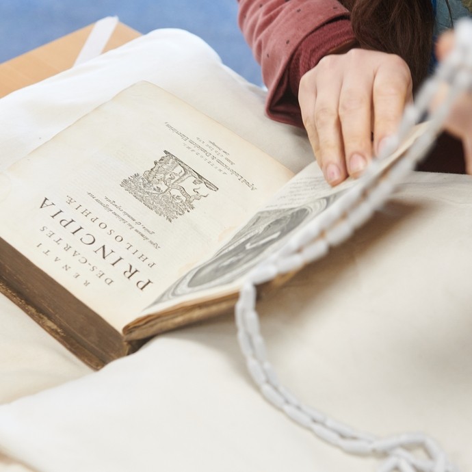 Student handling an old book