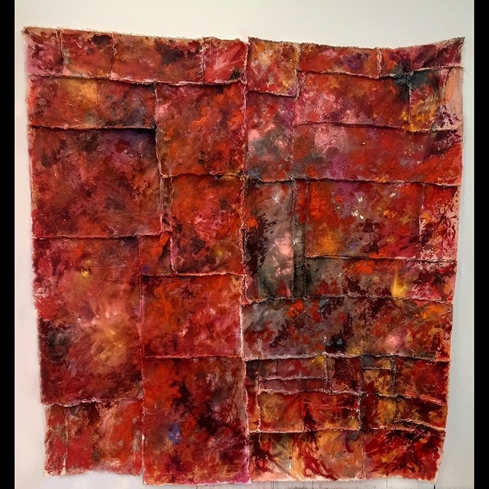An abstract painting made of splashes of fiery colour divided by textured boundaries into squares.